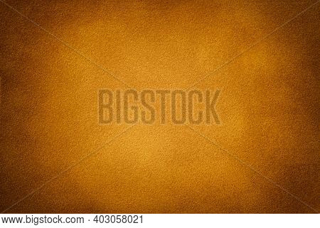 Dark Orange Matte Background Of Suede Fabric With Vignette, Closeup. Velvet Texture Of Seamless Gold