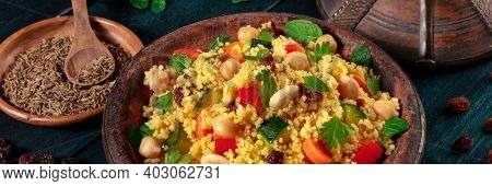 Couscous Panorama. Kuskus With Vegetables, Herbs, Almonds, Raisins On A Dark Wooden Background