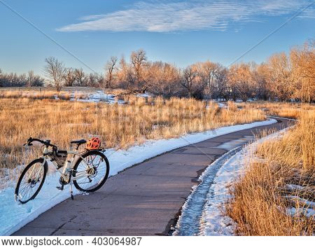 touring bicycle in late fall or winter scenery - one of numeous bike trail in Fort Collins, northern Colorado, recreation and commuting concept