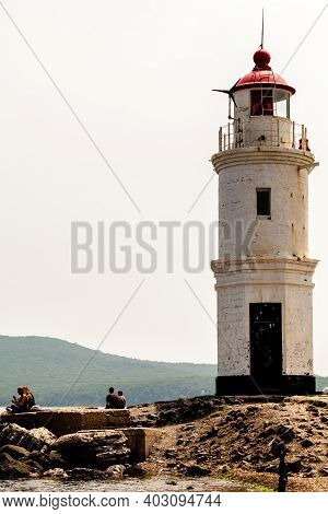 Vladivostok, Russia - July 30, 2015: Tourists Resting Near Lighthouse. The Old Japanese Lighthouse E