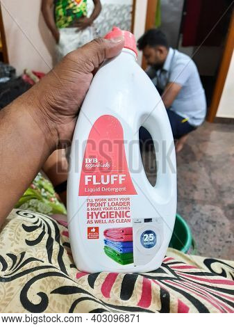 Closeup Of Man Holding Ifb Fluff Liquid Detergent Container Or Plastic Bottle At Home