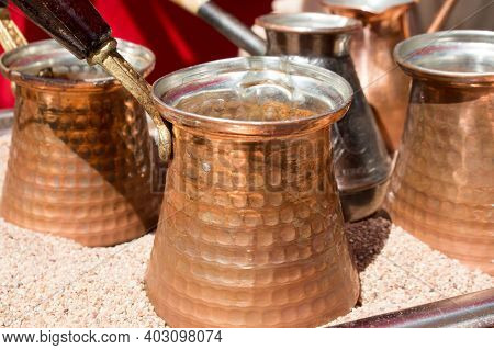 The Turkish Coffee In Cezve In The Hot Sand