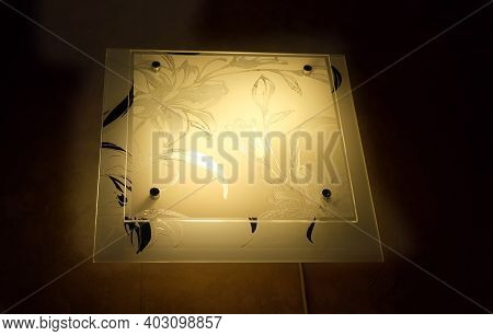 Square Duplex Ornate Lamp In The Dark. Sconce With Elegant Floral Pattern On  Wall Background With C