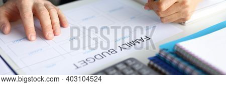 Close-up Of Couple Accounting Family Budget. Paper For Planning Wastes On Every Month. Man And Woman