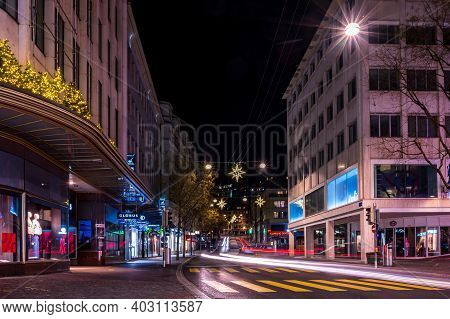 Lausanne, Vaud , Switzerland - 01.10.2021: Car Light Trails Over Lausanne City At Night. Beautiful A