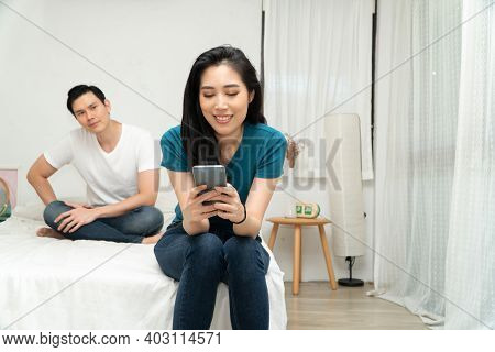 Asian Husband Feeling Suspicious Of My Wife's Abnormality In Smartphone Use And His Wife Ignores Him
