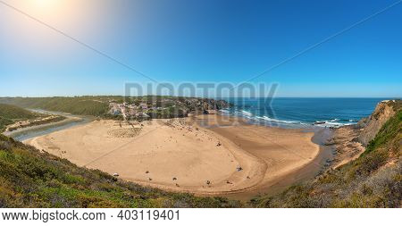 Delightful Panoramic View Of The Portuguese Beach Of The Village Of Odeceixe With Tourists In Summer