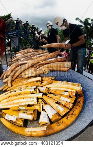 Bangkok ,thailand-august 26 , 2015 : Government Officials An Unknown Man Is Destroying The Seized Iv