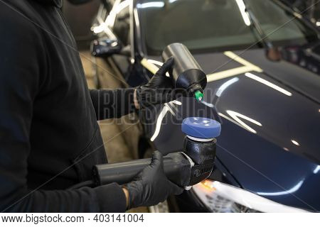 Detailing Master Applies Car Polish Paste To The Polisher. Vehicle Paintwork Polishing Concept