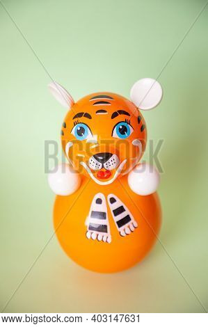 Bright Plastic Toy-tumbler As Orange Tiger On Green Background