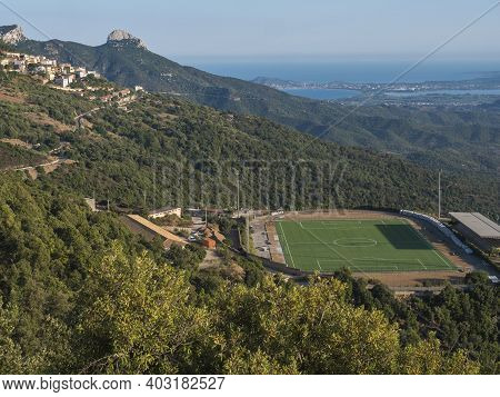 Aerial View Of Green Soccer Field At Baunei Village In Beautiful Landscape Of Supramonte Mountains W