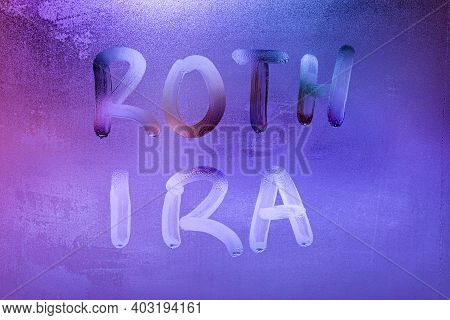 The Words Roth Ira Handwritten On Night Wet Window Glass Surface