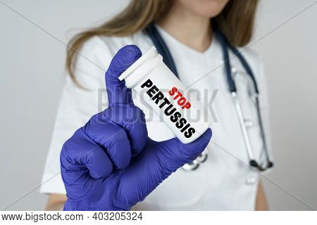 Medicine And Health Concept. The Doctor Holds A Medicine In His Hands, Which Says - Stop Pertussis