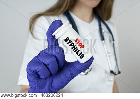 Medicine And Health Concept. The Doctor Holds A Medicine In His Hands, Which Says - Stop Syphilis