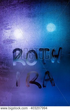 The Words Roth Ira Handwritten On Night Wet Window Glass Surface