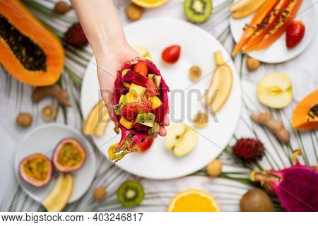 Exotic Fruits And Tropical Leaves On Table