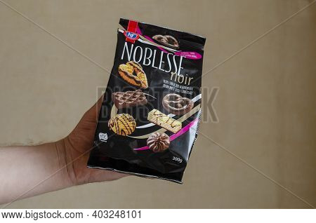 Hans Freitag's Noblesse Noir, Assortment Of Biscuits & Wafers Dark Chocolate In A Man's Hand - Ukrai