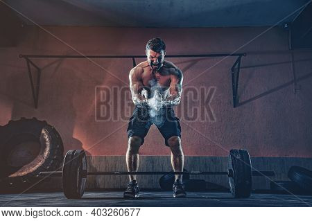 Muscular Fitness Man Preparing To Deadlift A Barbell Over His Head In Modern Fitness Center. Functio