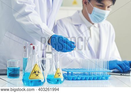 Two Asian Scientist Team Reserch Chemistry Science Tube Experiment Biotech Antibody Sample In Labora