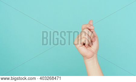 Empty Hand Holding Or Catch Nothing Guesture On Green And Blue Or Mint Background.