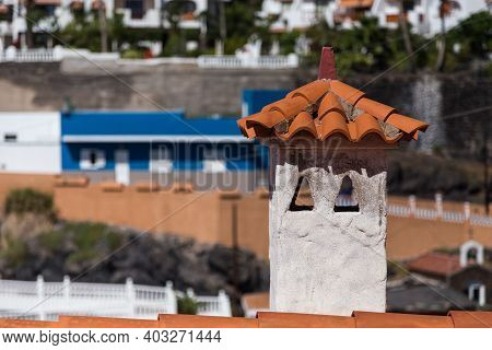 Orange Shingle Roof With Chimney In Mediterranean Style, Buildings At The Background.