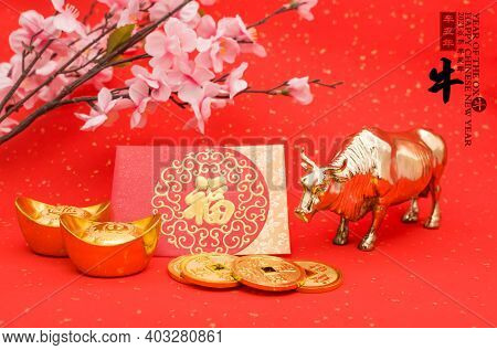 Tradition Chinese 2021 is year of the ox,Chinese characters on rightside mean chinese wording and seal mean:Chinese calendar for the year.leftside and gold ingot translation:good bless for money.