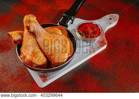Top View.convenience Food,pree Cooked.chicken Marinated Dramstick On A Background Of Red Paprika. Ra