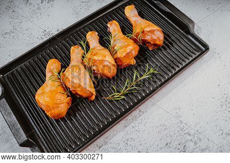 Marinated Chicken Dramstick On A Griddle Pan. Top View.convenience Food,pree Cooked.raw Chicken For 
