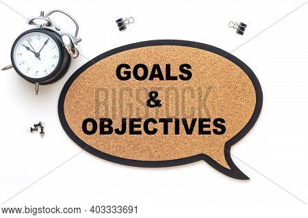 Goals And Objectives On Suberic Balloon And Isolated Over White Background With Black Alarm Clock. B