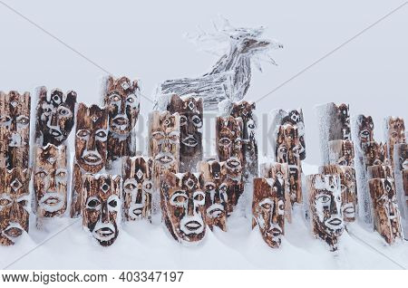 Perm Krai, Russia - January 02, 2021: Snow-covered Wooden Art Object - Group Of Idols Depicting Anth