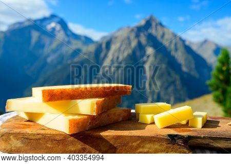 Cheese Collection, French Comte, Beaufort Or Abondance Cow Milk Cheese Served Outdoor With Alps Moun