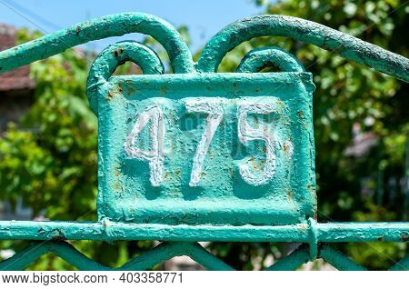 House Number Plate 475 On A Metal Fence. Street Number. Address Number.