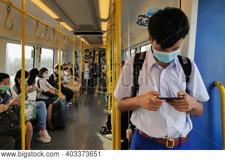 Bangkok, Thailand - January 15, 2021 : Asian Student And The Passengers In Sky Train Public Transpor