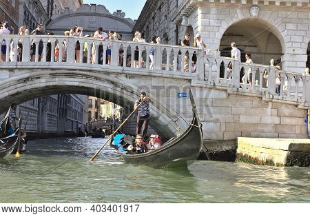 Venice, Italy - 3 August, 2016: Tourists Enjoying The Gondolas In The Canals Near The Bridge Of Sigh
