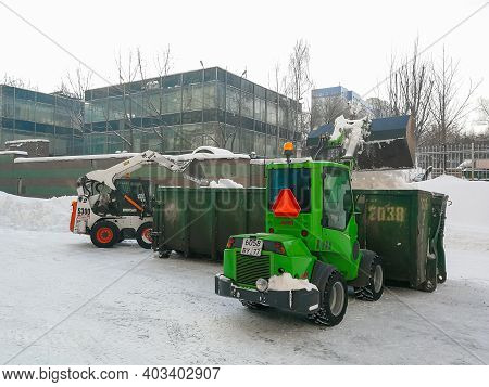 Moscow. Russia. January 15, 2021. Small Front-end Loaders Clear Snow From The Street And Load Into A