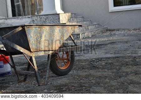 Wheelbarrow In An Under Construction Site, Villa Mansion Under Construction, Architectural Ground Wo