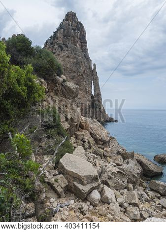 View Of Pedra Longa, Limestone Rock Pillar At Coast Gulf Of Orosei, Beginning Of The Famous And Diff