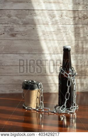 Beer Bottle And Coffee Glass To Go With Chains With A Wooden Base As A Measure Of Closure For Hotels