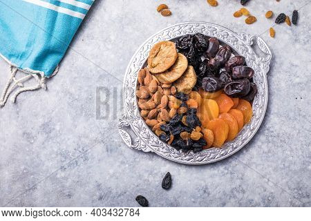 Dried Fruits And Nuts Mix In A Wooden Bowl. Assortment Of Candied Fruits. Judaic Holiday Tu Bishvat.