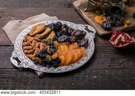 Dried Fruits And Nuts Mix In A Wooden Bowl. Assortment Of Candied Fruits. Judaic Holiday Tu Bishvat.