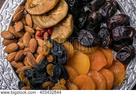 Dried Fruits And Nuts Mix In A Wooden Bowl. Assortment Of Candied Fruits. Judaic Holiday Tu Bishvat.