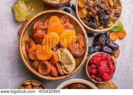 Assortment Of Nuts And Dried Fruits. Dried Fruits And Nuts Mix In A Wooden Bowl. Assortment Of Candi