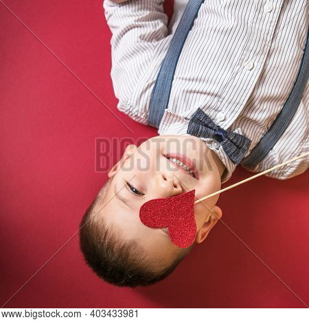 Five Year Old Smiling Boy Holding A Red Heart On Eays  Symbol Of Love, Family, Hope. Backgrounds For