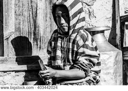 Jhong, Nepal - November 8, 2015: Nepali Boy Cutting Potatoes Near His House, Black And White Image