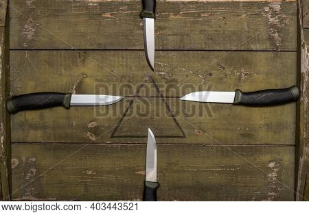 Several Knives Directed To The Center. Sharp Knives Flying To The Center. Flat Lay.