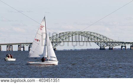 Babylon, New York, Usa - 7 December 2019: Sailboat Sailing With The Great South Bay Bridge In The Ba