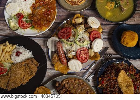 Variety Of Typical Dishes Of Colombian Gastronomy. Picada, Tripe, San Cocho, Paisa Tray.
