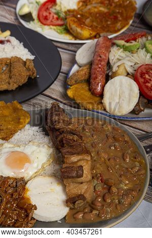 Variety Of Typical Dishes Of Colombian Gastronomy. Picada, Tripe, San Cocho, Paisa Tray.