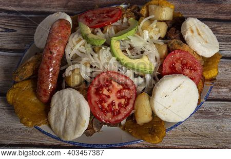 Variety Of Typical Dishes Of Colombian Gastronomy. Picada, Tripe, San Cocho, Paisa Tray.