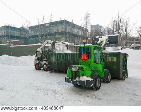 Moscow. Russia. January 15, 2021. Small Front-end Loaders Clear Snow From The Street And Load Into A